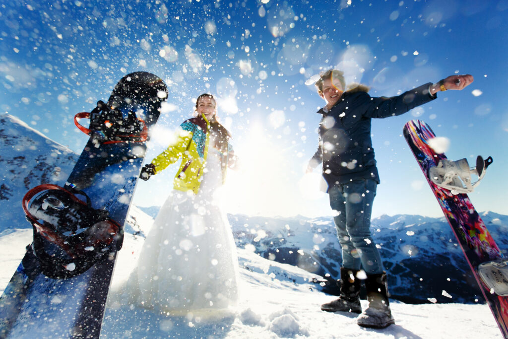 A couple throwing snow at a ski resort